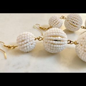Dangle 3-ball earrings with gold hooks.